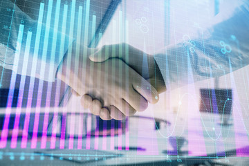Multi exposure of financial graph on office background with two businessmen handshake. Concept of success in business