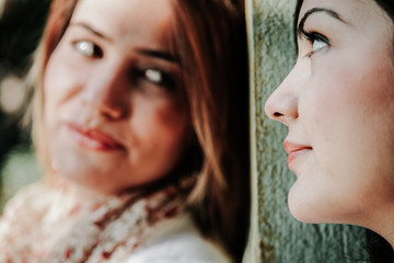 Young girlfriends loving each other at the park