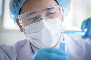 Fototapeta premium Asian man scientist researching and learning in a laboratory.