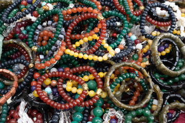 Closeup Background of amulet bracelet or necklace in india market.