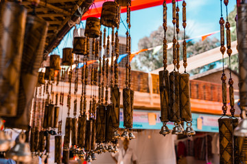 Wooden windchimes with musical bells for sale at Dilli Haat, an outdoor handicraft bazaar market in New Delhi India