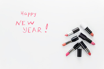 Christmas tree made of lipsticks with the inscription 