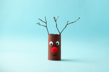 Paper reindeer for Happy new year Merry Christmas party. Easy craft for kids on blue background,...