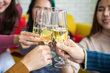 Friends celebrating Christmas or New Year eve party with champagne