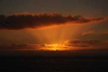 Naklejka na ściany i meble Sunset on lake Beautiful summer evening. Dramatic sky. Sea ocean and clouds with sun rays.