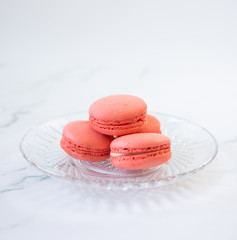 Sweet red macaroon on a glass plate. Gift for Valentine's Day