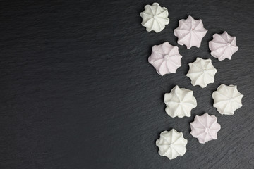 background of meringue cookies in white and pastel pink