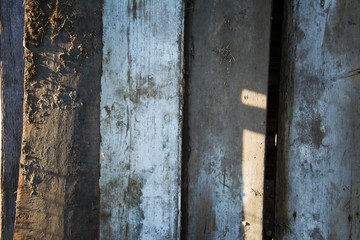Texture of old dirty gray wooden fence of rough unpainted boards. Textured background. Front view.
