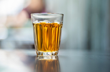 Glass cup with tea bag on table, close up