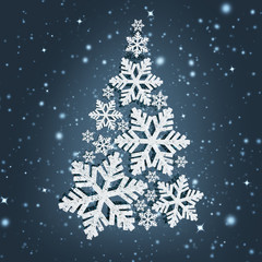 Fototapeta na wymiar Creative Christmas tree of white snowflakes on a blue snowy background.