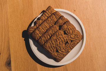 a Dutch specialty 'speculaas' cookie. Wooden table as a background.