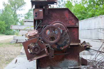 Fototapeta na wymiar part of an old rusty concrete mixer. Pulley on the motor.