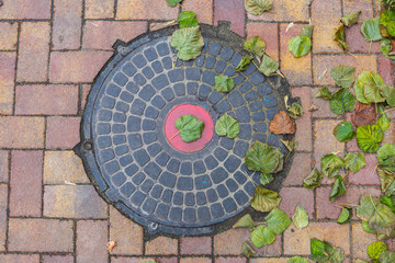 Rusty manhole cap, grunge manhole cover, round.