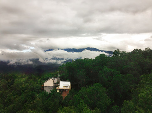 Cloudy Drone View On Great Smoky Mountains Green Forest With A Cabin In Gatlinburg 