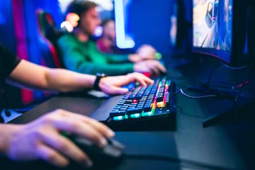 Fotobehang Gaming Professional cyber video gamer studio room with personal computer armchair, keyboard for stream in neon color blur background. Soft focus  © Parilov