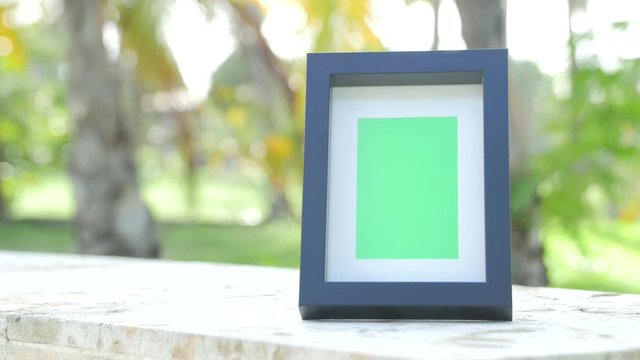 Picture frame with greenscreen product shot with tropical background