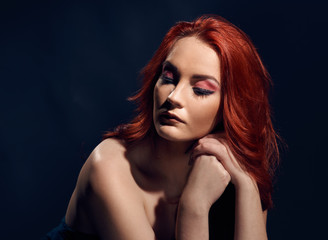 Fashionable portrait of beautiful redheaded model with naked shoulders