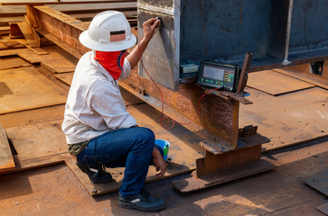 The inspectors are checking defect in welded of steel add joint with process Ultrasonic testing...