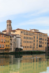 Fototapeta na wymiar Winter view of the Arno River and medieval houses with their reflections in the water, Florence, Italy