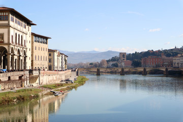 Fototapeta premium View to embankment of Arno river with bridge and medieval buildings, Florence, Italy