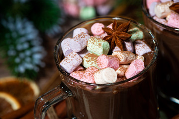sweet hot chocolate with marshmallows in glass mugs, closeup