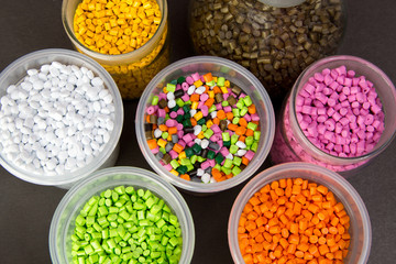 Plastic pellets. Dyes for plastic, polypropylene, polyethylene. Plastic granules in a measuring container and test tubes in the laboratory.