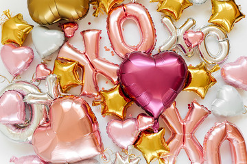 XOXO foil balloon letters and air balloons of heart shaped and stars. Love concept. Holiday and...