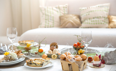 The interior of the room with a festive Easter table .