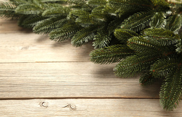 Christmas tree branch on grey wooden table.