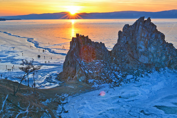Shamanka rock in winter at sunset. Khuzhir, Olkhon island, Baikal lake, Siberia, Russia.