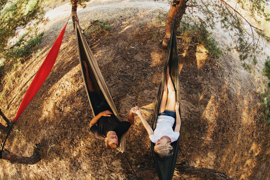 Romantic Couple Relaxing In Hammock In The Forest. Top View