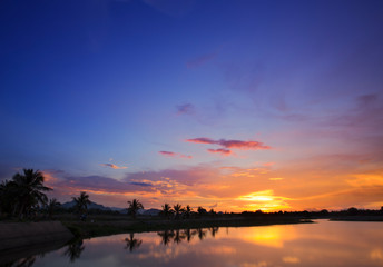 Fototapeta na wymiar Beautiful sunset sky over tropical beach and sea