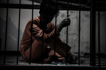 Asian man desperate at the iron prison,prisoner concept,thailand people,Hope to be free,Serious...