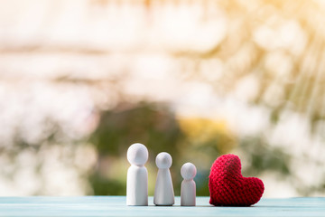 Family and red heart put on the wood on the sunlight in the public park, for love concept.