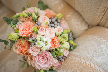 Wedding bouquet in shades of dusty rose, white, green, beige, pink and purple. Beautiful and delicate bridal bouquet close up. Top view.
