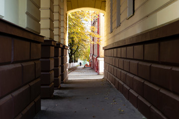 Arch at the house in warm colors. The view of the alley . Autumn