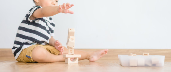 2 years baby boy.Little child boy playing with lots of wooden toys block with mother.Kids play with educational toys at home.Day care and Kindergarten school.child development concept. - obrazy, fototapety, plakaty