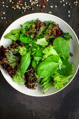 Healthy salad, leaves mix salad (mix greens, cucumber, onion, other ingredients). food background. copy space