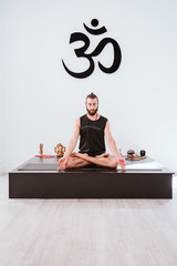 young man practicing yoga sport at the gym. Healthy lifestyle