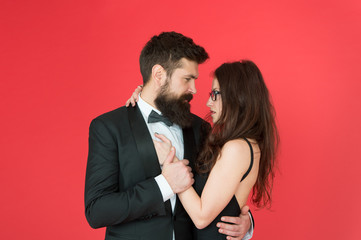 We are together. Couple in love red background. Loving couple hug in formal wear. Married couple celebrate wedding anniversary. Couple of sensual woman and bearded man. Valentines day. Romance. Love