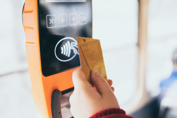 Payment of public transport ticket fare at automatic contactless machine with a card