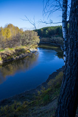 Fototapeta na wymiar Beautiful river among the forest and ravines. Among the birches and pines.