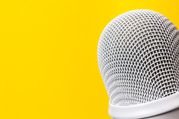 Silver Microphone on yellow background