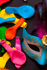 CARNIVAL MASK NEXT TO COLOR BALLOONS . FEBRUARY MONTH OF CARNIVAL PARTY