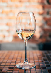 glass of white wine on wooden table