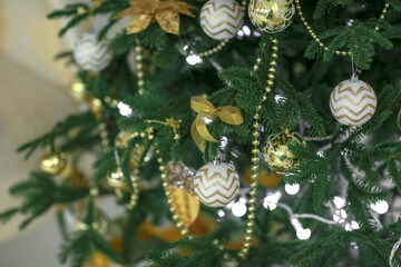 Christmas tree branch closeup with light toys on it.