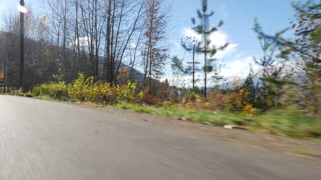 Moving Along Road Beside British Columbia Forest With Mountains 02