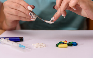 Obraz na płótnie Canvas Girl addict with heroin spoon. Drug addict training. Social problems