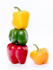 Obraz na płótnie Canvas Four organically grown bell peppers stacked and are different colors