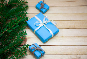 Christmas toys with fir branches on a wooden table, gift box, empty place, New Year concept. View from above.